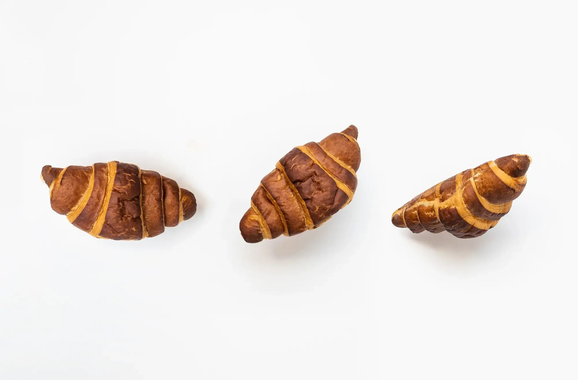 Golden croissants in air fryer served on a breakfast plate