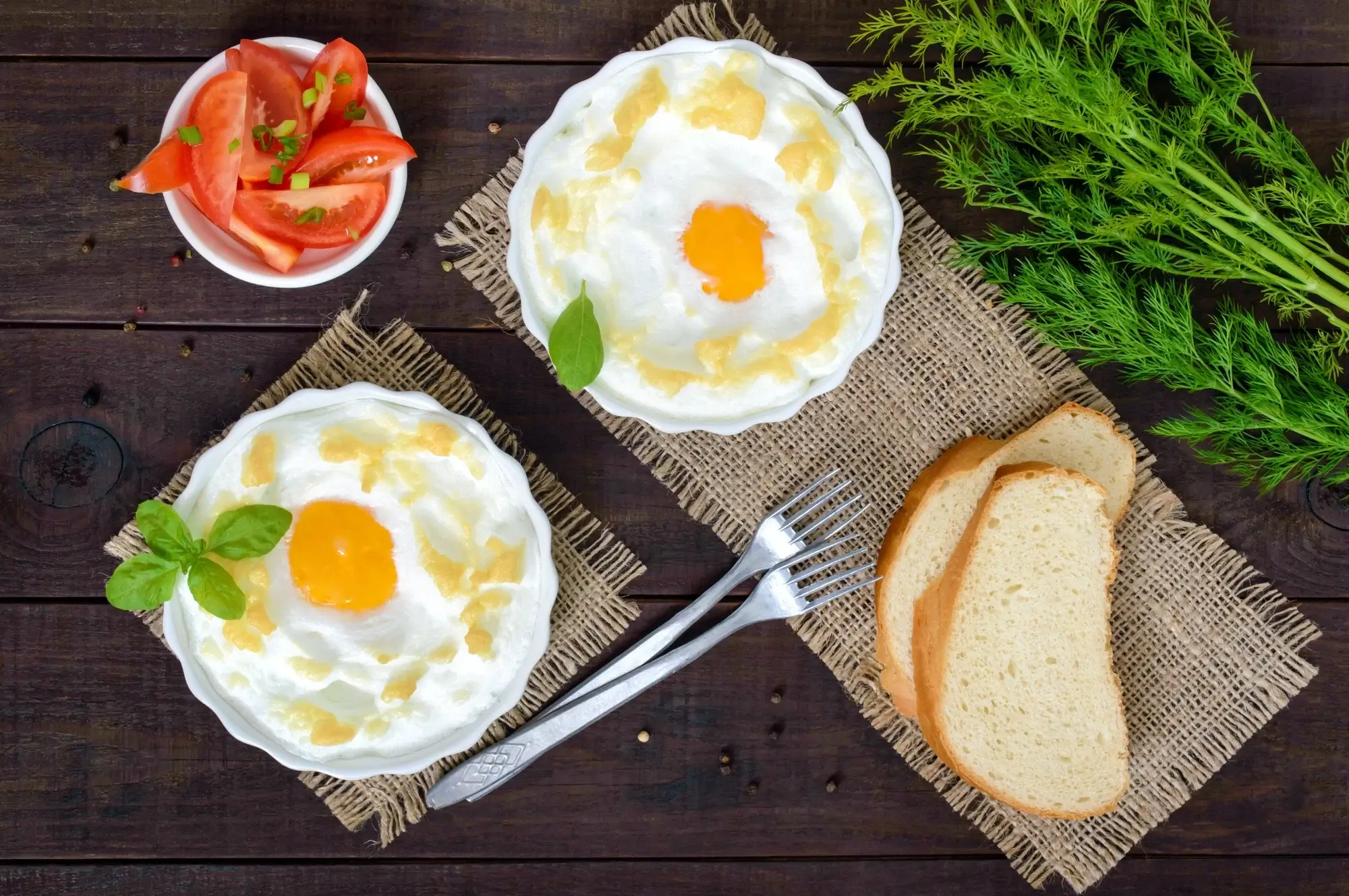 Cooked eggs in air fryer displayed in basket and ramekin