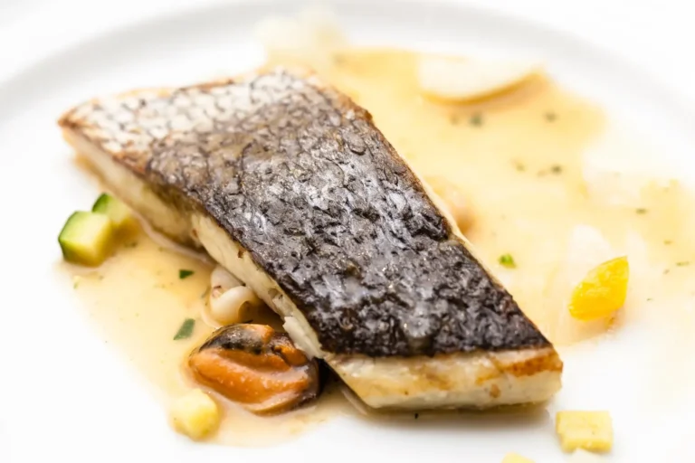 Crispy fish fillets in air fryer served with lemon wedges