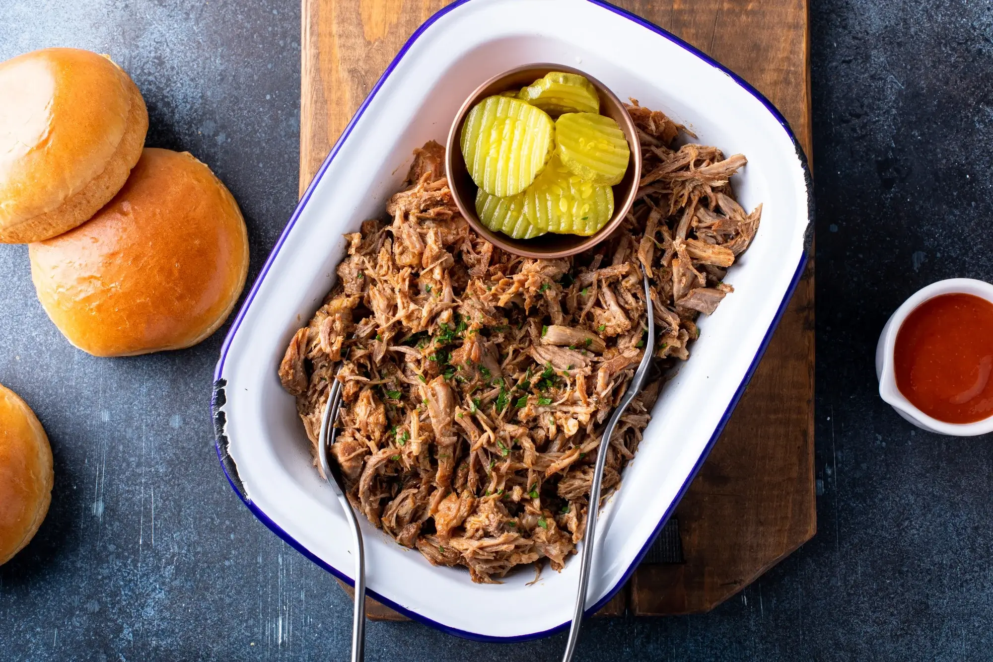 Shredded pulled pork in air fryer served in a bun with slaw