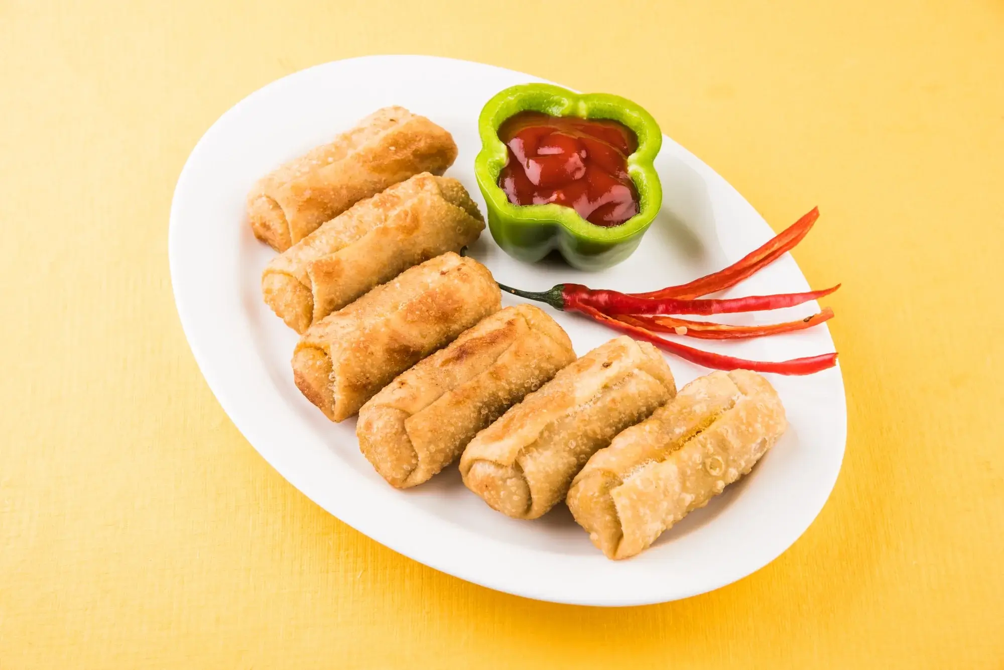 Spring rolls in air fryer served with dipping sauce