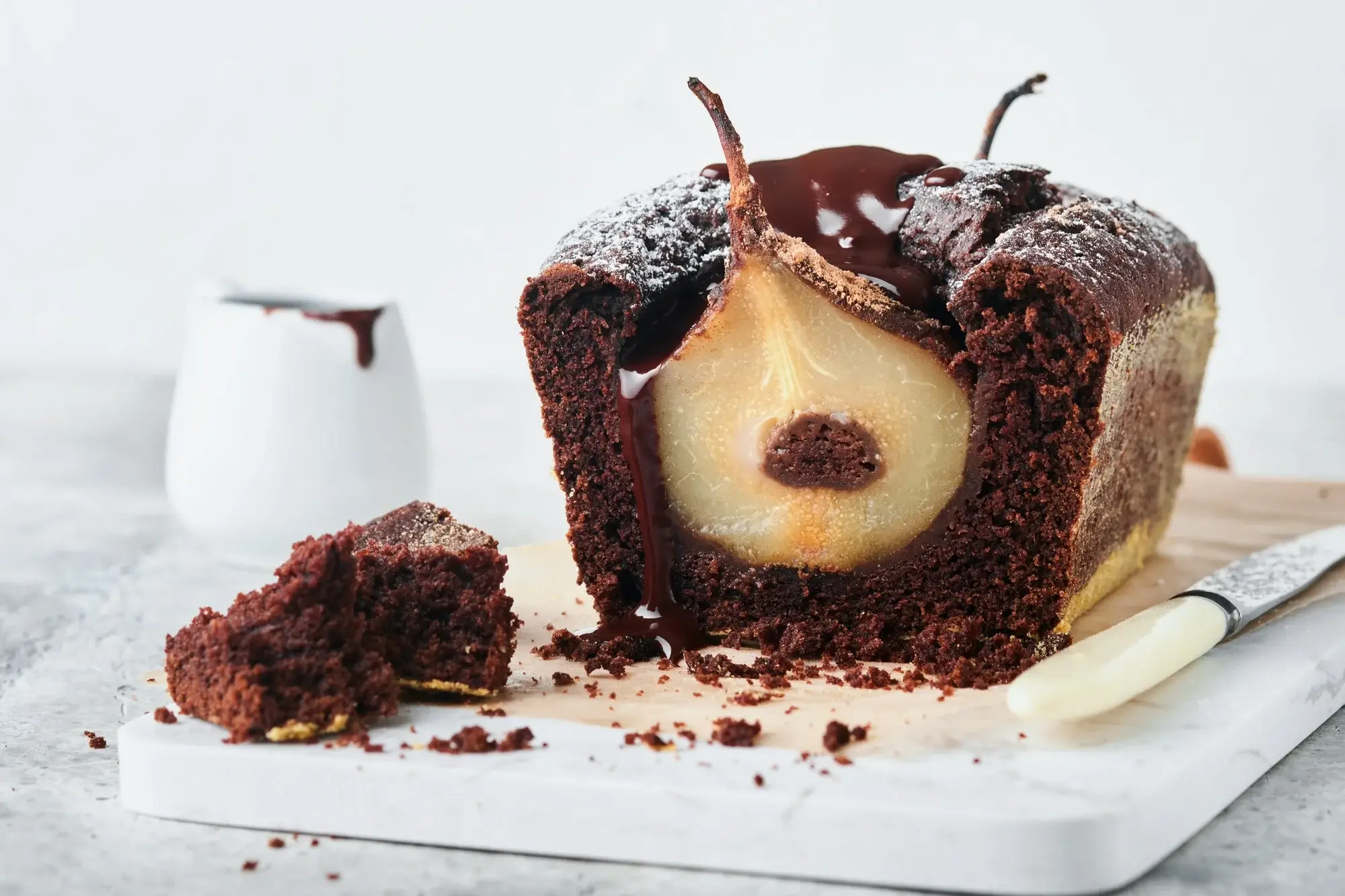 Chocolate cake in air fryer served on a plate with icing sugar