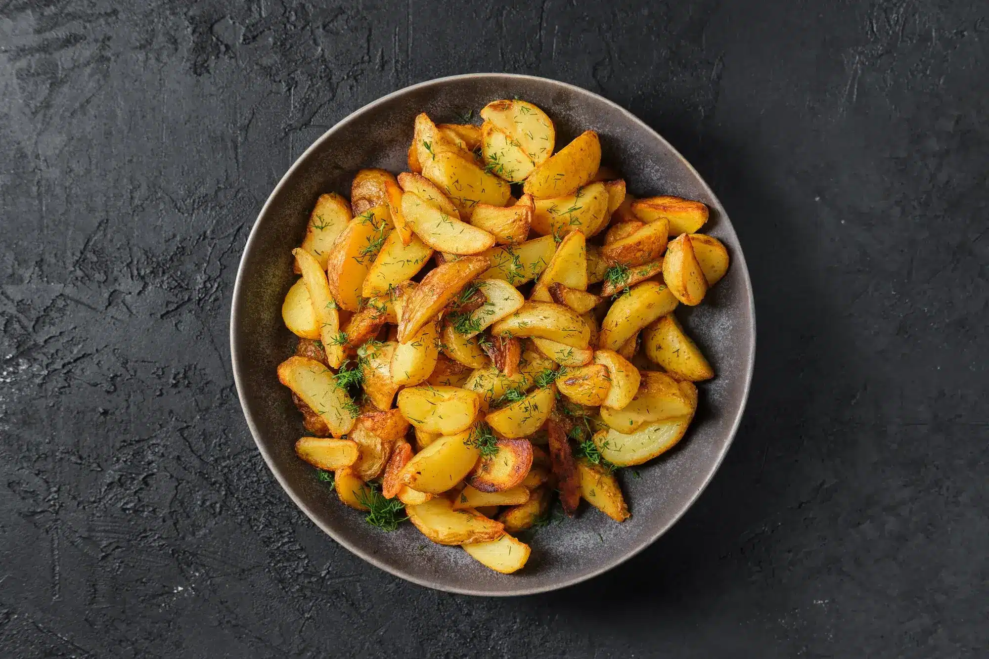 Crispy golden potato wedges in air fryer with dip